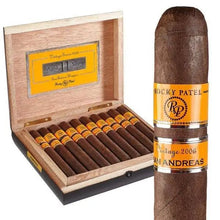 Load image into Gallery viewer, Medium flavored Rocky Patel Vintage '06 Churchill cigar resting on a wooden surface with a colorful cigar band visible.