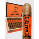 Camacho Nicaragua Churchill sweet-flavored cigar with a dark wrapper, displayed on a wooden surface, showcasing its band and rich texture.