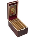 Cao Gold Churchill mild flavor cigar with gold band, displayed on a wooden surface, showcasing its smooth wrapper and premium quality.